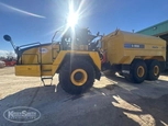 Side of used Komatsu Water Truck under sun